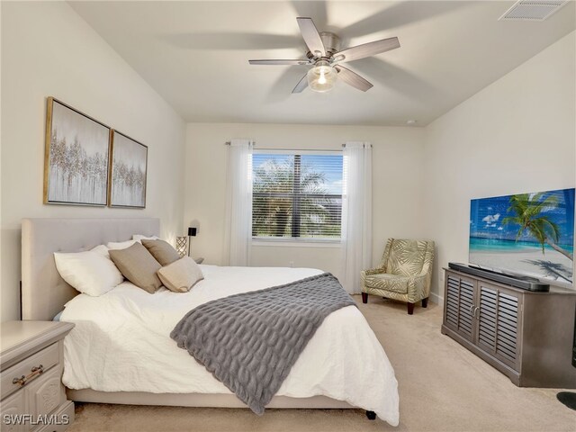 bedroom with ceiling fan and light colored carpet