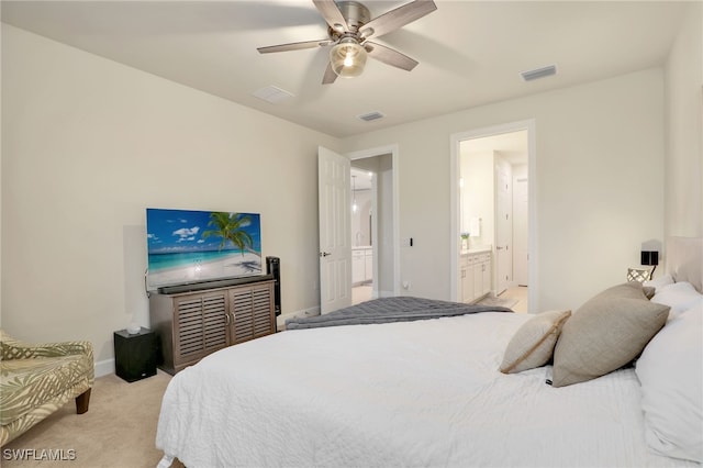 bedroom featuring light carpet, connected bathroom, and ceiling fan