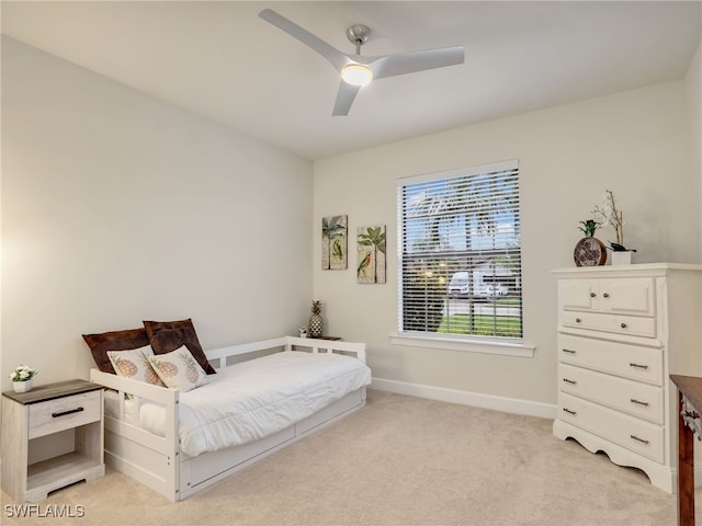 bedroom featuring light colored carpet and ceiling fan