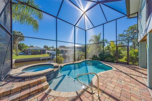 view of pool featuring an in ground hot tub, a lanai, and a patio area