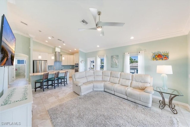 living room featuring vaulted ceiling, ceiling fan, ornamental molding, and light tile patterned floors