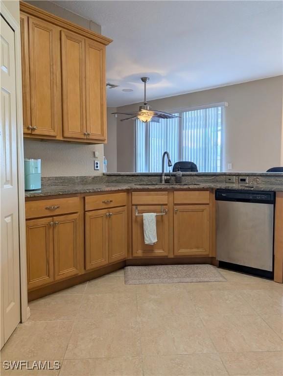 kitchen with a sink, ceiling fan, brown cabinets, and dishwasher