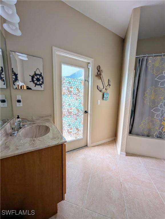 full bath featuring a shower with shower curtain, tile patterned flooring, and vanity