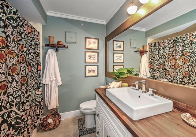 bathroom with toilet, vanity, tile patterned floors, and ornamental molding