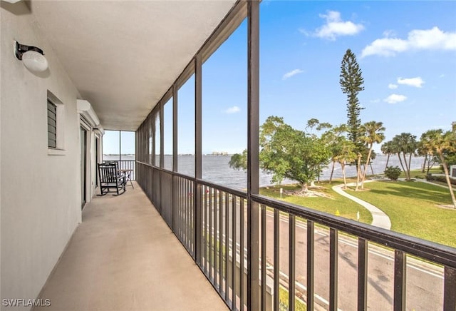 unfurnished sunroom featuring a water view