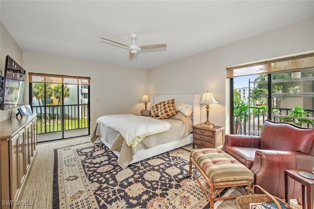 carpeted bedroom with multiple windows, access to exterior, and ceiling fan