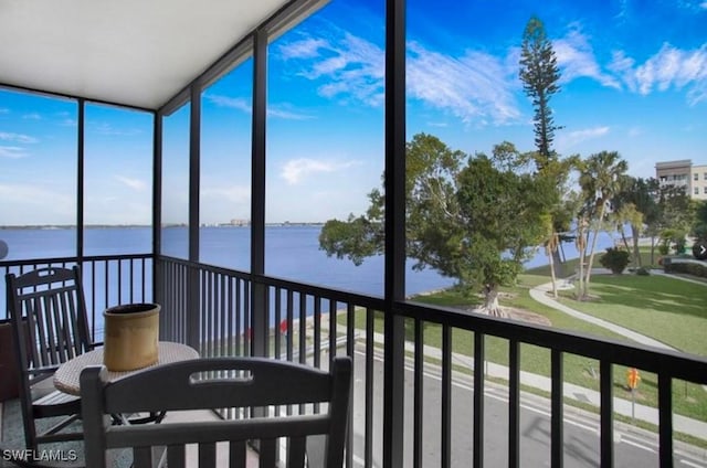 sunroom / solarium with a water view