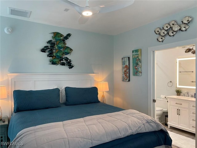 bedroom with ceiling fan, ensuite bathroom, sink, and light wood-type flooring