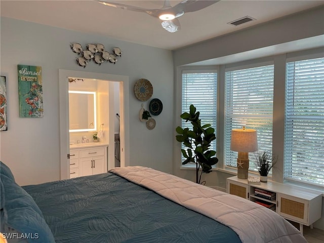 bedroom featuring multiple windows and ensuite bath