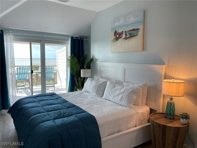 bedroom with vaulted ceiling, a water view, and access to outside