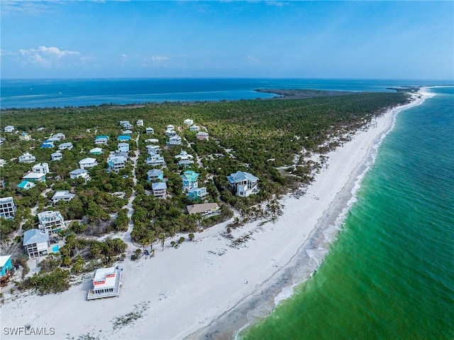 birds eye view of property featuring a view of the beach and a water view