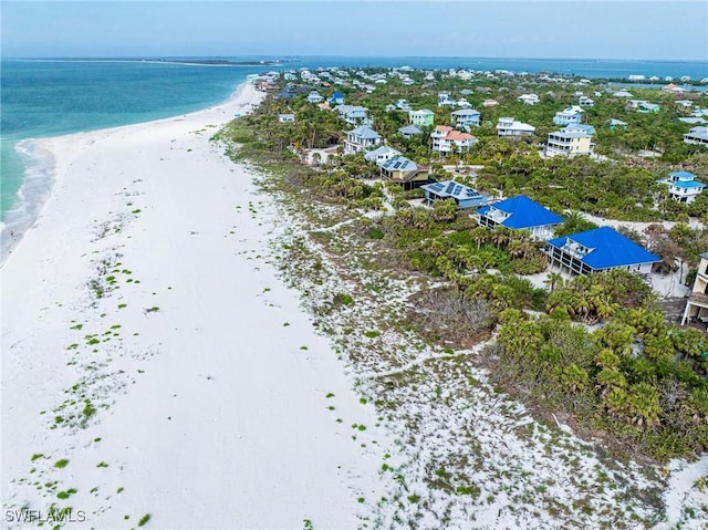 birds eye view of property featuring a water view and a view of the beach