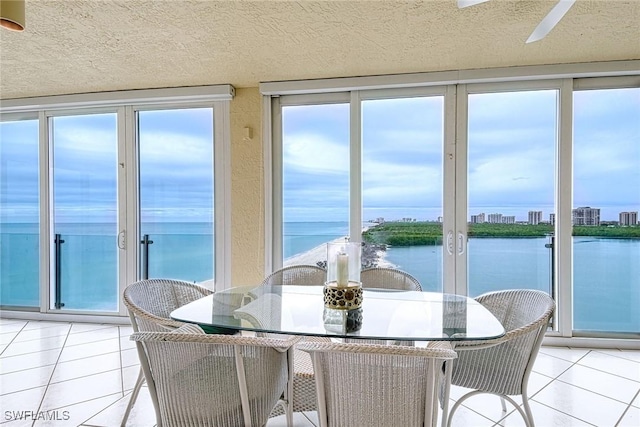 sunroom featuring a healthy amount of sunlight and a water view