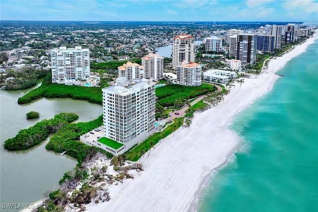 drone / aerial view featuring a water view and a beach view