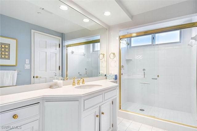 bathroom featuring vanity, a shower with shower door, and tile patterned floors