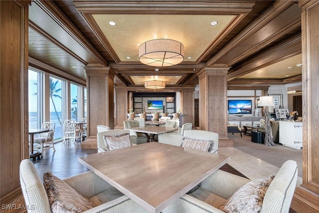 carpeted dining space featuring crown molding, decorative columns, and a water view