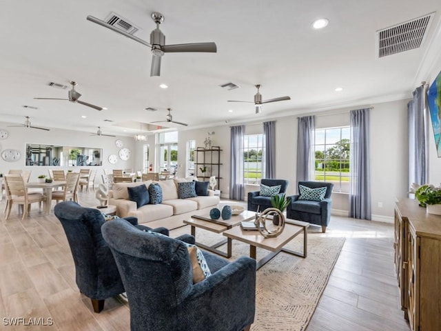 living room with crown molding and light wood-type flooring