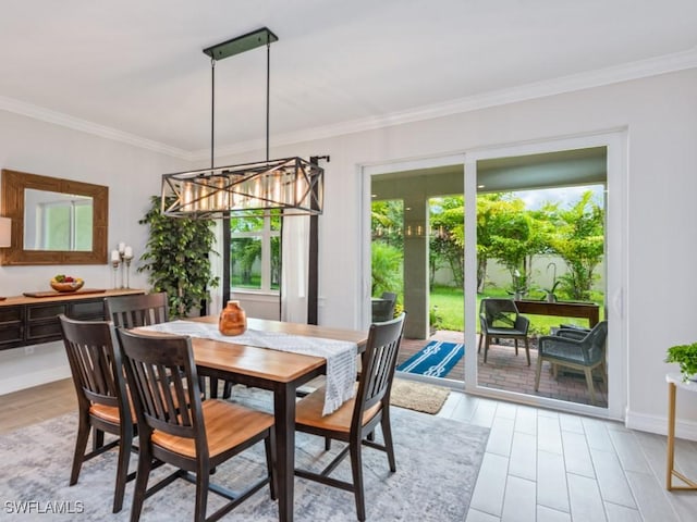 dining space with light hardwood / wood-style flooring and ornamental molding