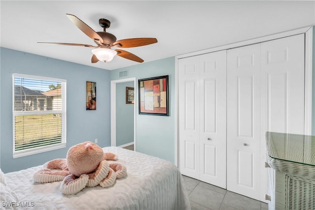 tiled bedroom with a closet and ceiling fan