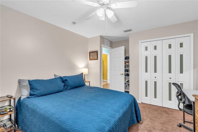 carpeted bedroom featuring ceiling fan and a closet