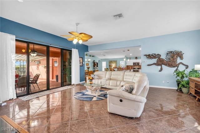 tiled living room featuring ceiling fan