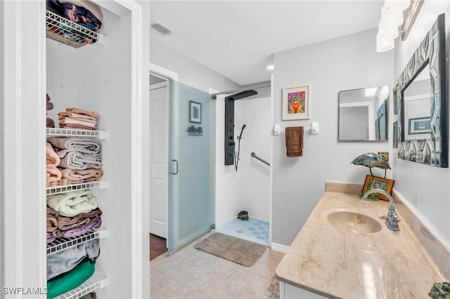 bathroom with vanity, tile patterned floors, and a shower with shower door