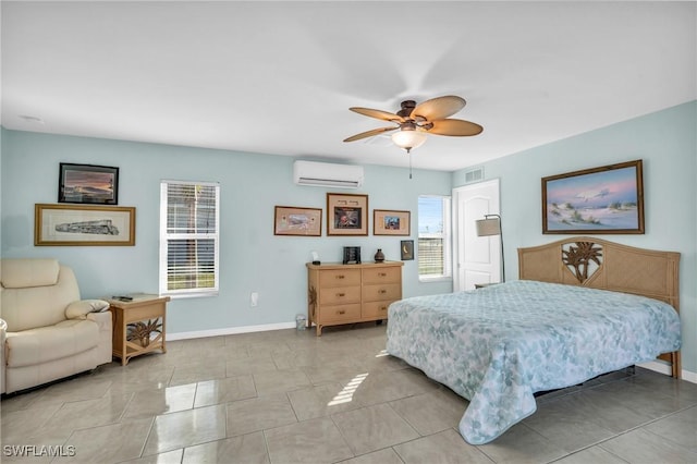 bedroom with a wall mounted AC, ceiling fan, and light tile patterned floors