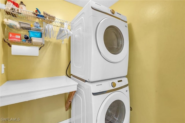 washroom with stacked washer and dryer