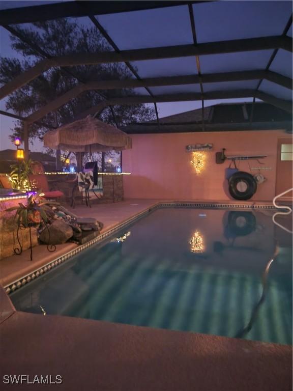 view of pool with a lanai and a patio