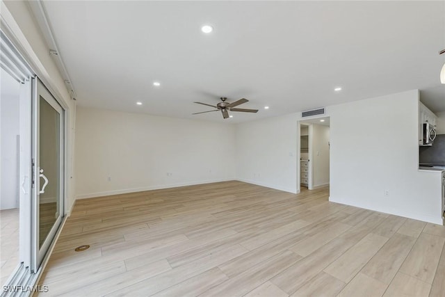 unfurnished living room with ceiling fan and light wood-type flooring