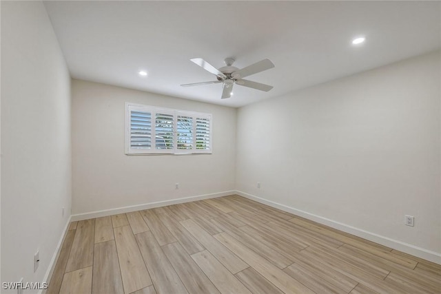 spare room with ceiling fan and light wood-type flooring