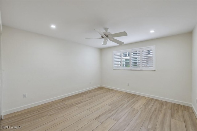 spare room featuring ceiling fan and light hardwood / wood-style floors