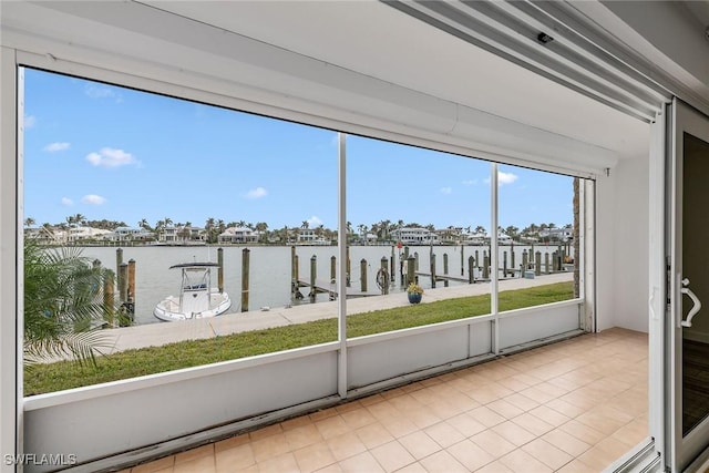 unfurnished sunroom with a water view