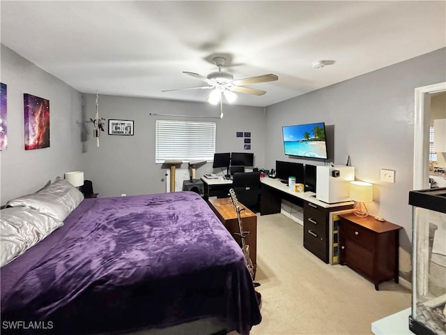 bedroom featuring ceiling fan and light carpet