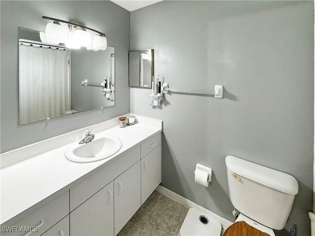 bathroom featuring toilet, vanity, and tile patterned flooring