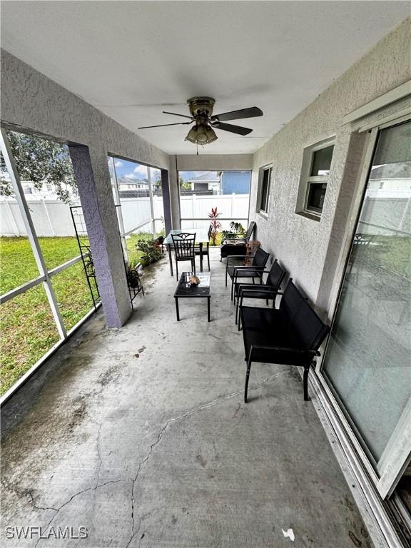 sunroom featuring ceiling fan