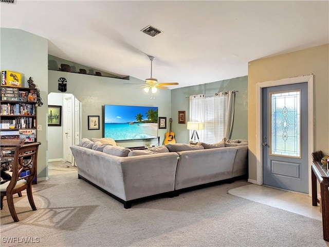 living room with ceiling fan, lofted ceiling, a healthy amount of sunlight, and light carpet