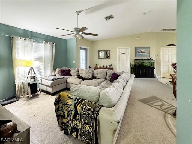 carpeted living room with vaulted ceiling and ceiling fan