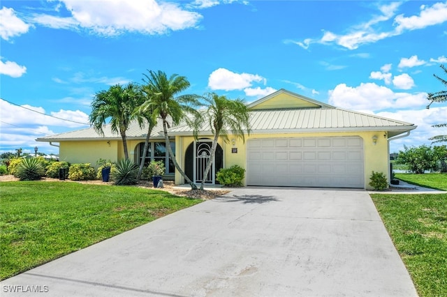 view of front of home with a garage and a front lawn