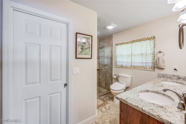 full bathroom with a shower stall, toilet, and a sink