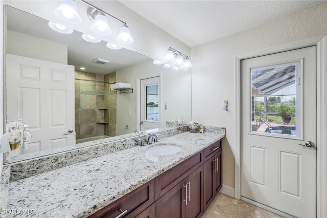 full bath featuring vanity, visible vents, and tile patterned flooring