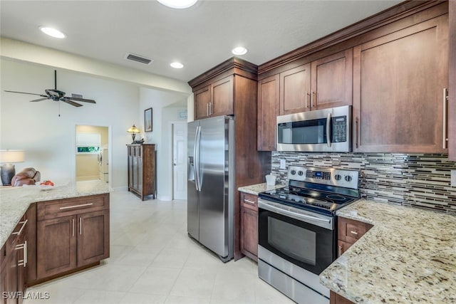 kitchen featuring tasteful backsplash, visible vents, washer and dryer, and appliances with stainless steel finishes