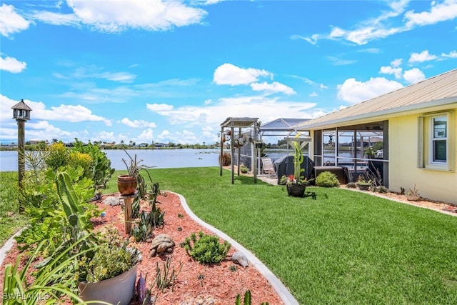 view of yard featuring glass enclosure and a water view