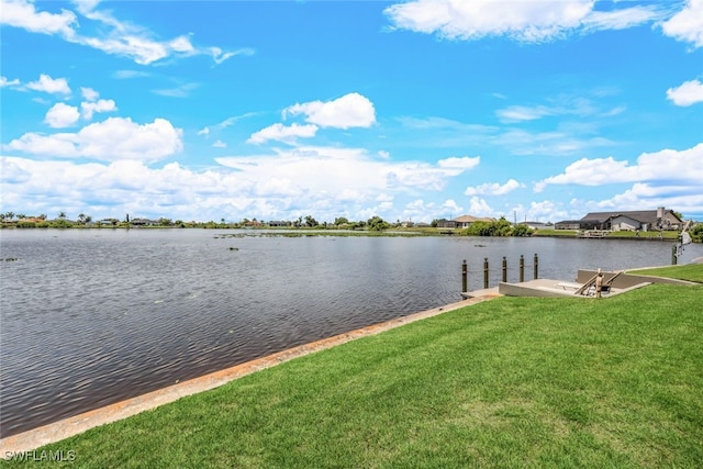 dock area featuring a yard and a water view