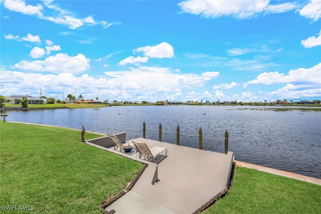 dock area featuring a water view and a lawn