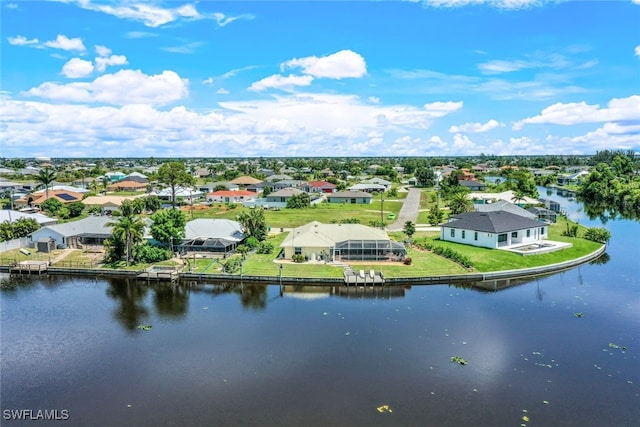 drone / aerial view featuring a residential view and a water view