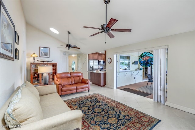 living room featuring light tile patterned floors, ceiling fan, baseboards, and lofted ceiling