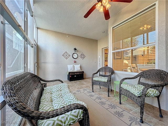 sunroom / solarium featuring plenty of natural light and ceiling fan