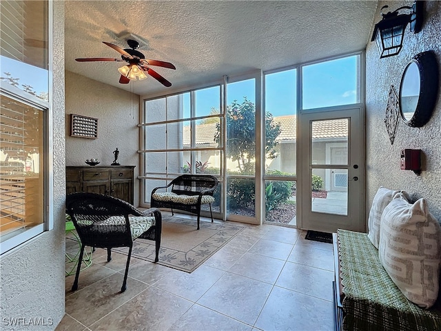 sunroom featuring ceiling fan