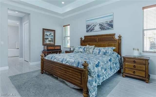 bedroom with ornamental molding and a tray ceiling